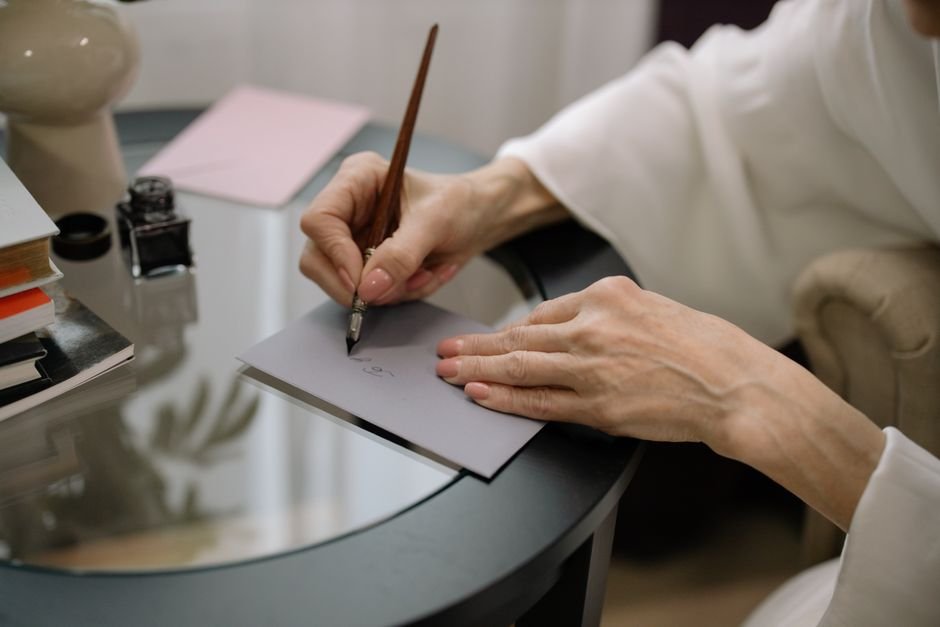 Veteran writing a VA buddy statement for asbestos claims at his desk